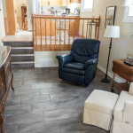 living area renovation Small renovated sitting room with dark grey floor tile and off-white painted walls.